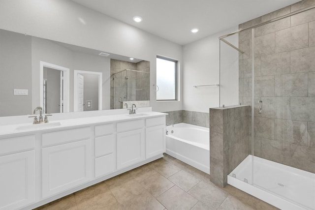 full bathroom featuring double vanity, a stall shower, a bath, and a sink