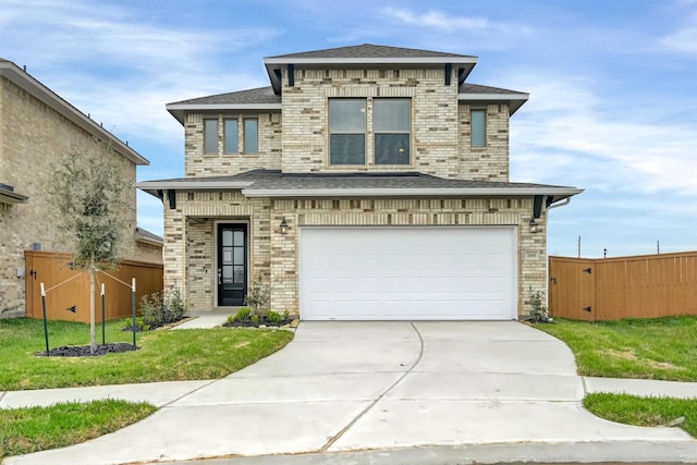 prairie-style home featuring concrete driveway, an attached garage, fence, and brick siding