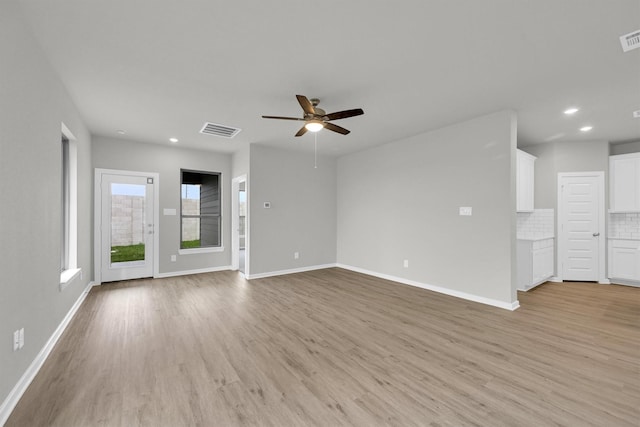 unfurnished living room featuring visible vents, recessed lighting, baseboards, and light wood-style floors