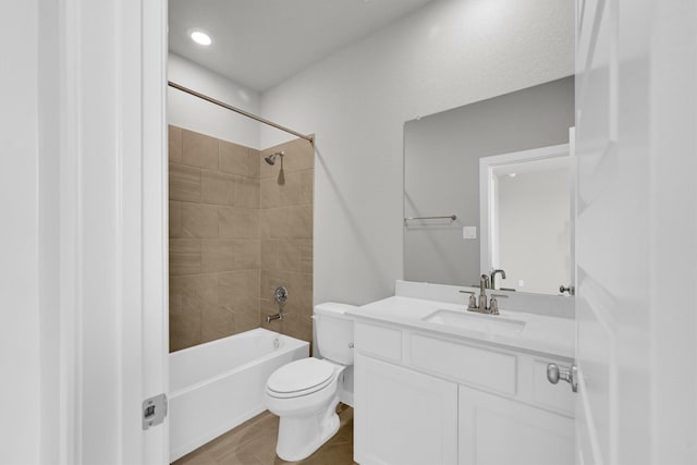 bathroom with toilet, vanity, and  shower combination