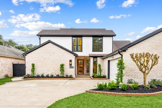 modern farmhouse style home with a garage and a front lawn