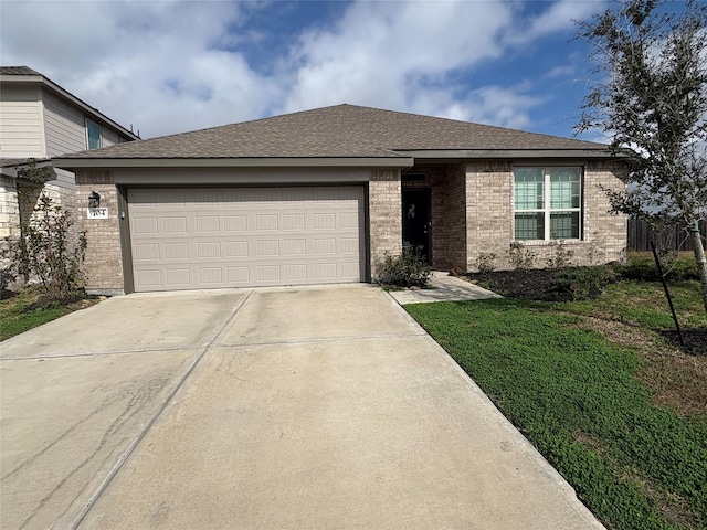 view of front of house featuring a front lawn and a garage