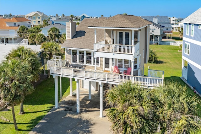 rear view of house with a carport and a balcony