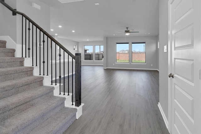 interior space featuring a ceiling fan, wood finished floors, recessed lighting, stairway, and baseboards