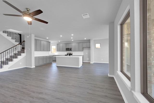 unfurnished living room featuring recessed lighting, visible vents, baseboards, and wood finished floors