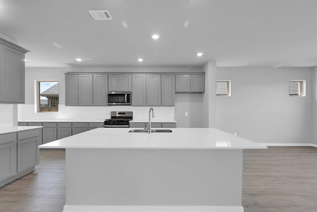 kitchen with a sink, appliances with stainless steel finishes, and gray cabinets