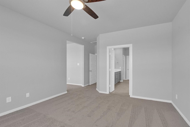 unfurnished bedroom featuring a ceiling fan, baseboards, carpet, and ensuite bathroom