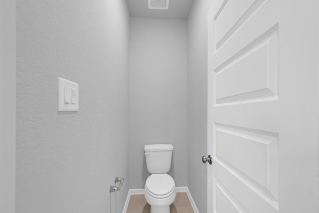 bathroom with tile patterned floors, visible vents, baseboards, and toilet