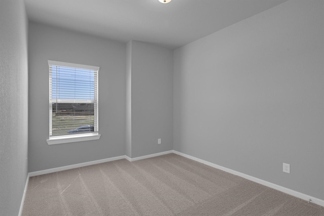 empty room with baseboards and carpet floors