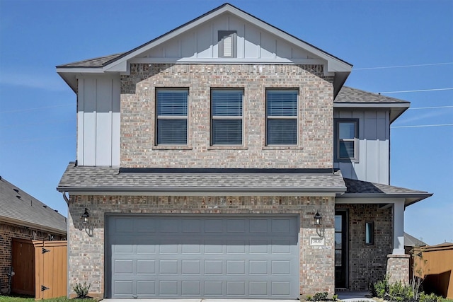 view of front of property featuring board and batten siding, a shingled roof, and a garage