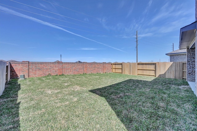 view of yard with a fenced backyard