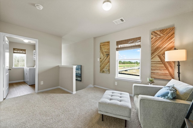 living area featuring light colored carpet