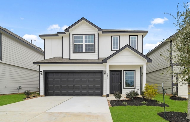 view of front of house featuring board and batten siding, an attached garage, driveway, and a front lawn