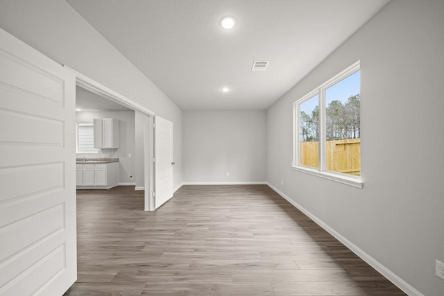 unfurnished room featuring baseboards, recessed lighting, visible vents, and light wood-style floors