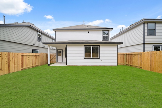 back of property with a patio, a lawn, and a fenced backyard