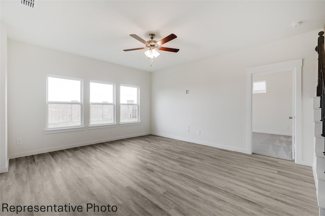 empty room featuring ceiling fan and light wood-type flooring