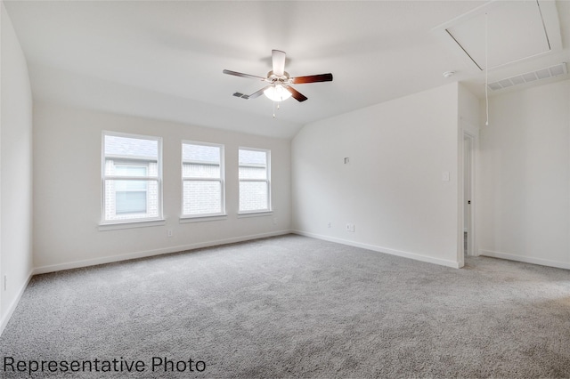 carpeted empty room with ceiling fan and vaulted ceiling