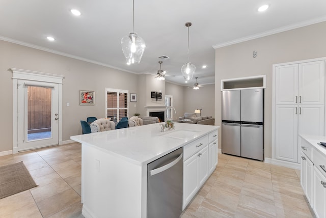 kitchen with pendant lighting, white cabinets, ornamental molding, a kitchen island with sink, and stainless steel appliances