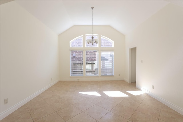 empty room with high vaulted ceiling, baseboards, a notable chandelier, and light tile patterned flooring