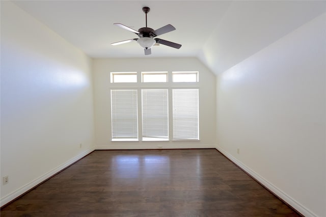 unfurnished room with ceiling fan, dark wood-type flooring, lofted ceiling, and baseboards