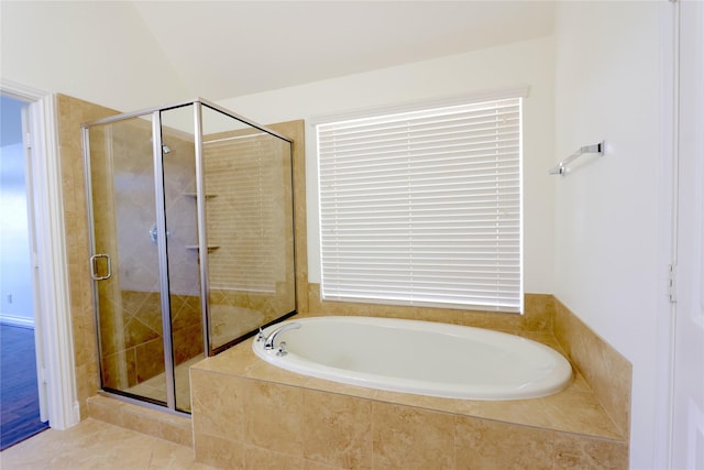 full bath featuring a stall shower, tile patterned flooring, and a garden tub