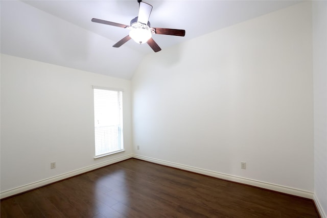 spare room featuring lofted ceiling, ceiling fan, baseboards, and dark wood finished floors