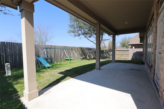 view of patio / terrace featuring a playground and a fenced backyard