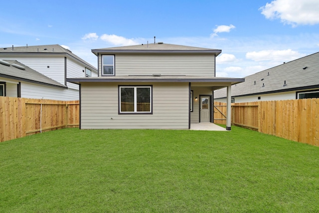 back of house with a patio area, a fenced backyard, and a lawn