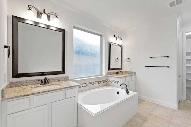 bathroom with a washtub, vanity, tile patterned floors, and ornamental molding