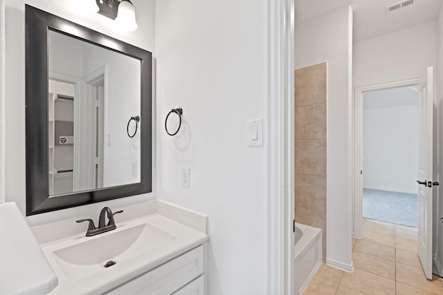 bathroom featuring tile patterned flooring, vanity, and tub / shower combination