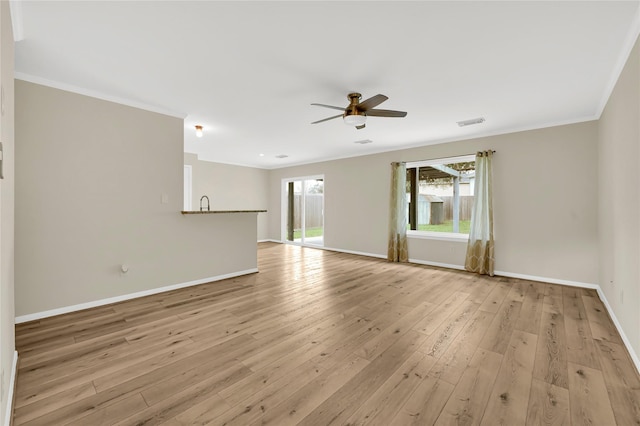 empty room featuring crown molding, ceiling fan, and light wood-type flooring