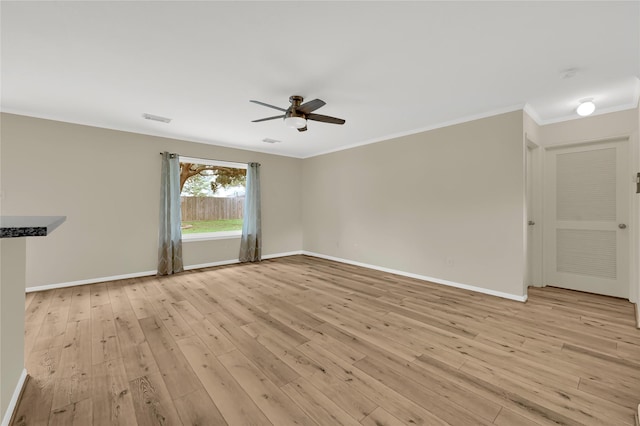 empty room with ceiling fan, ornamental molding, and light hardwood / wood-style flooring