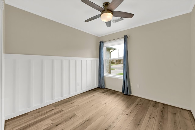 unfurnished room featuring ornamental molding, ceiling fan, and light wood-type flooring