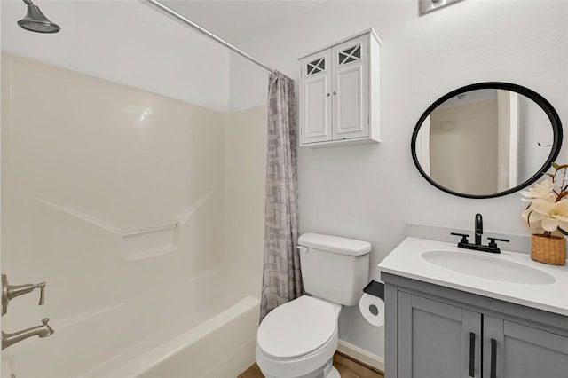 full bathroom with vanity, shower / tub combo, and toilet