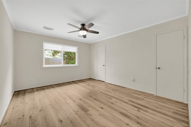 spare room featuring light hardwood / wood-style flooring, ornamental molding, and ceiling fan