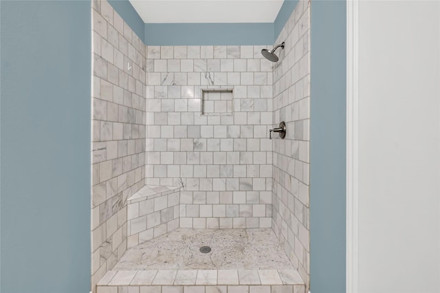 bathroom with a tile shower