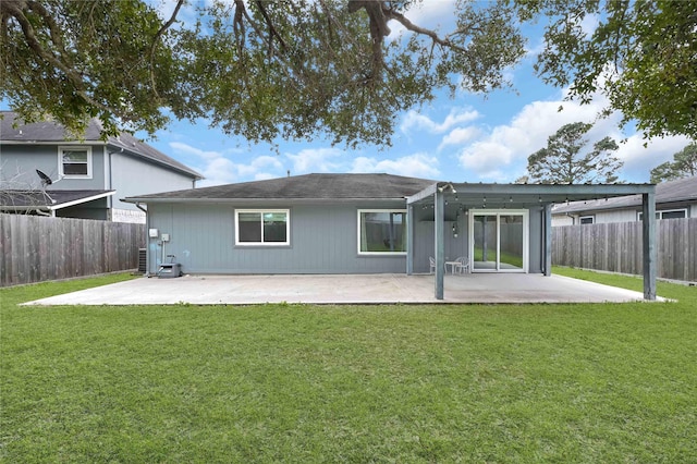 rear view of house with a yard and a patio