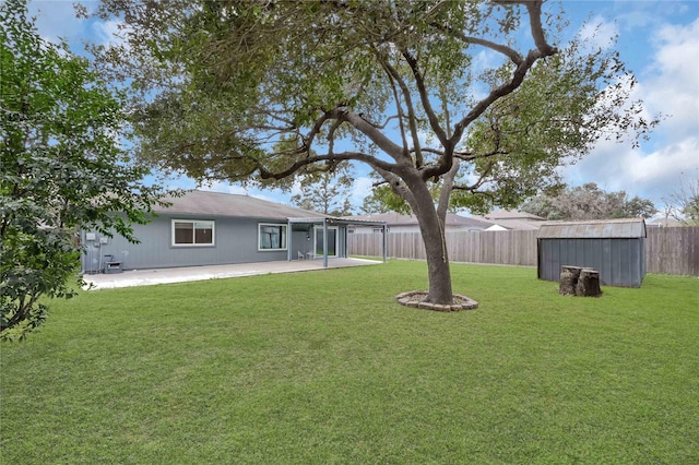 view of yard with a storage unit and a patio area