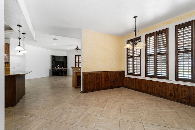 803 S Converse St, Flatonia, TX 78941 - unfurnished room featuring ceiling fan with notable chandelier and wood walls