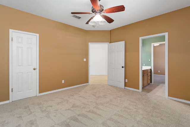 803 S Converse St, Flatonia, TX 78941 - unfurnished bedroom featuring ensuite bath, light colored carpet, and ceiling fan