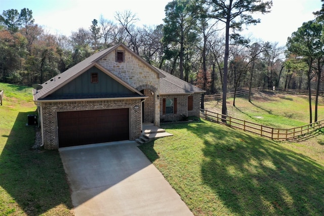 view of front of home featuring a garage and a front lawn