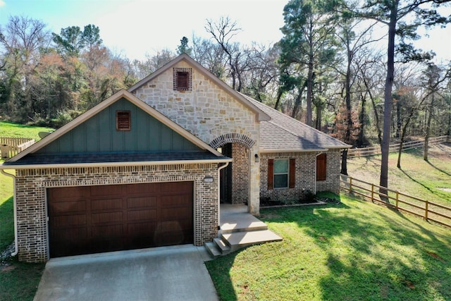 view of front of home featuring a garage and a front yard