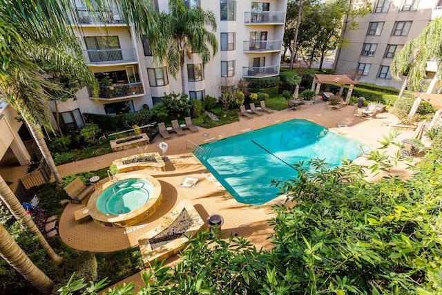 view of pool featuring a patio and a community hot tub