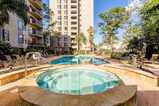 view of pool featuring a patio area and a hot tub