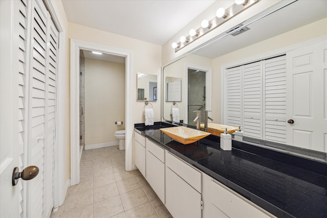 bathroom with tile patterned floors, toilet, and vanity