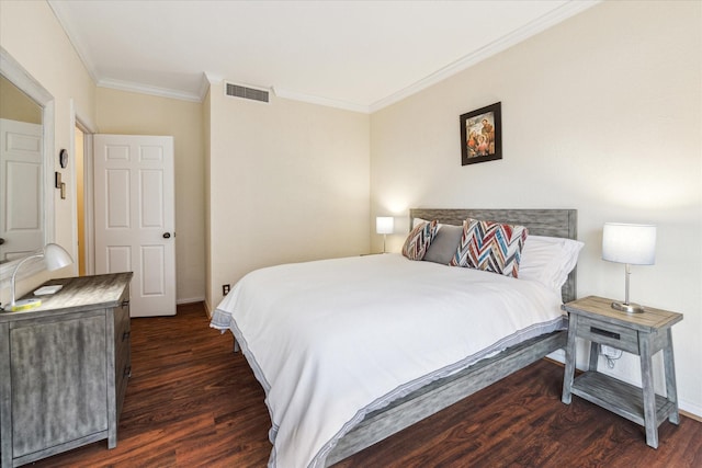 bedroom with crown molding and dark hardwood / wood-style floors