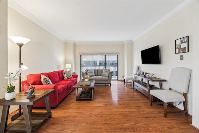 living room with dark wood-type flooring and ornamental molding