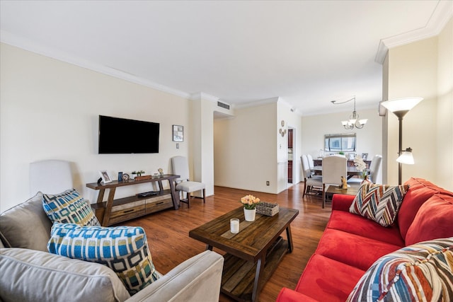 living room featuring ornamental molding, an inviting chandelier, and dark hardwood / wood-style flooring