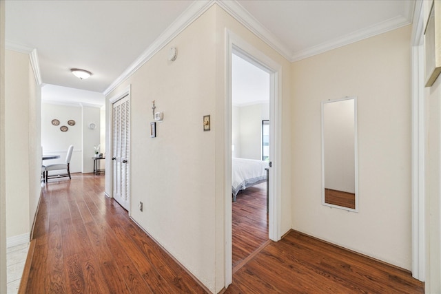 hallway featuring dark wood-type flooring and ornamental molding