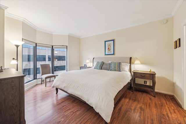 bedroom featuring crown molding and dark hardwood / wood-style flooring